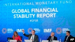 
Tobias Adrian, second from left, monetary and capital markets department director at the International Monetary Fund, speaks at a news conference during the 2022 annual meeting of the IMF and the World Bank Group, Oct. 11, 2022, in Washington. 