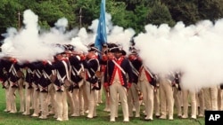 FILE — Re-enactors portraying members of the American forces during the Revolutionary War fire their rifles during a re-enactment celebrating the 225th anniversary of the Battle of Brooklyn, Aug. 18, 2001.