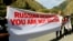 FILE - Activists hold an anti-Russian banner during an action organized by political party Droa near the border crossing at Verkhny Lars between Georgia and Russia in Georgia, Sept. 28, 2022. Some Georgians hace voiced concerns about the exodus of Russians into their country.