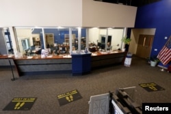 Leon County Supervisor of Elections employees now work behind bullet resistant glass and kevlar-reinforced walls amid heightened security measures ahead of the midterm elections in Tallahassee, Florida, Oct. 5, 2022.