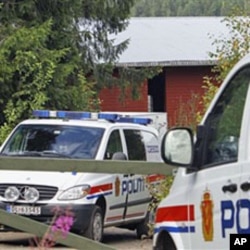 Norwegian police cars sit in front of the farm of Anders Behring Breivik, the suspect in the twin terror attacks that killed 76 people in Oslo and on Utoya island, in Asta, central Norway, July 28, 2011