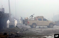 FILE - Security forces inspect the site of a suicide bomb attack in Kabul, Afghanistan, Nov. 29, 2018. Taliban insurgents staged a deadly coordinated attack targeting a British security firm in the Afghan capital Wednesday.