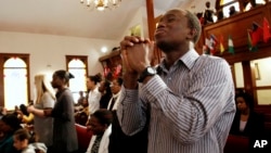 FILE - Congregants at the historic Black church Pentacostal Tabernacle pray during a service in Cambridge, Mass., Feb. 27, 2011.