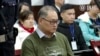 FILE - In this image taken from video and released Nov. 28, 2017, by the Intermediate People's Court of Yueyang, Taiwanese rights activist Lee Ming-Che sits during a court session at the Intermediate People's Court of Yueyang in Yueyang, in central China'