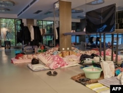 A community worker takes a nap at a temporary bed at a gym in a compound during a COVID-19 lockdown in Pudong district in Shanghai, April 13, 2022.