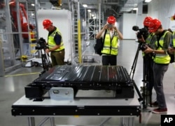 FILE - A Tesla battery pack is displayed during a media tour of the new Tesla Motors Inc., Gigafactory Tuesday, July 26, 2016, in Sparks, Nevada. (AP Photo/Rich Pedroncelli, File)
