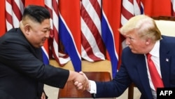 Sjevernokorejski lider Kim Jong Un rukuje se sa predsjednikom SAD Donaldom Trumpom na sastanku 30. juna 2019. godine (Foto: Brendan Smialowski / AFP)