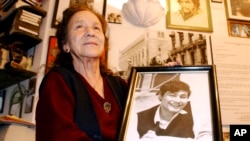FILE - Mexico's human rights activist Rosario Ibarra de Piedra shows a photo of her son Jesus who disappeared during Mexico's so called "dirty war", Nov. 5, 2003. Ibarra's struggle to learn the fate of her son helped develop Mexico's human rights movement.
