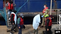 Members of the British military assist UK Border Force officers as migrants disembark at the port of Dover after being picked up crossing the English Channel from France on April 14, 2022.