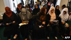 A group of Afghan women activists attend a press conference in Kabul on March 27, 2022, to demand reopening of secondary schools for girls across the country.