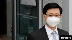 Former Hong Kong Chief Secretary for Administration and Chief Executive election candidate John Lee, leaves at the electoral affairs office after submitted his candidacy, in Hong Kong, April 13, 2022. 