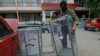 A Pro-Russian activist carries a ballot box away from a polling station preparing to smash it, in Donetsk, Ukraine, May 23, 2014. 