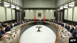 A handout made available by the Presidential Palace Press Office on January 19, 2015 shows Turkey's President Recep Tayyip Erdogan (Rear) presiding over the cabinet meeting at the presidential palace in Ankara, Jan. 19, 2015.