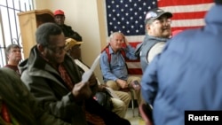 A group of U.S. veterans await a clothing giveaway at St. Anthony Foundation in San Francisco, California November 8, 2013. 