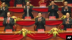 Vietnam's Communist Party leaders applaud upon their arrival at the opening ceremony of the 11th National Party Congress, Hanoi, Vietnam, Jan 12, 2011.