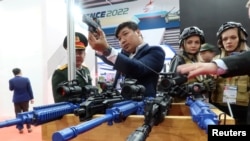 FILE - People look at weapons kept on display at the Vietnam International Defence Expo 2022, in Hanoi, Vietnam, Dec. 8, 2022.