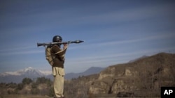 A Pakistani soldier secures a road in Khar, the main town in Bajaur Agency, located in Pakistan's Federally Administered Tribal Areas along the Afghanistan border, March 2, 2010.