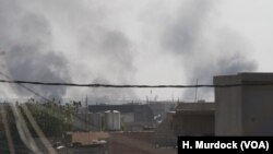 Smoke rises from a large apartment complex as militants exchange fire with Iraqi soldiers in Mosul, Nov. 19, 2016. 