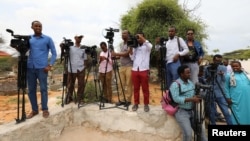 FILE - Somali journalists prepare to cover an event on the outskirts of Mogadishu, July 25, 2019.