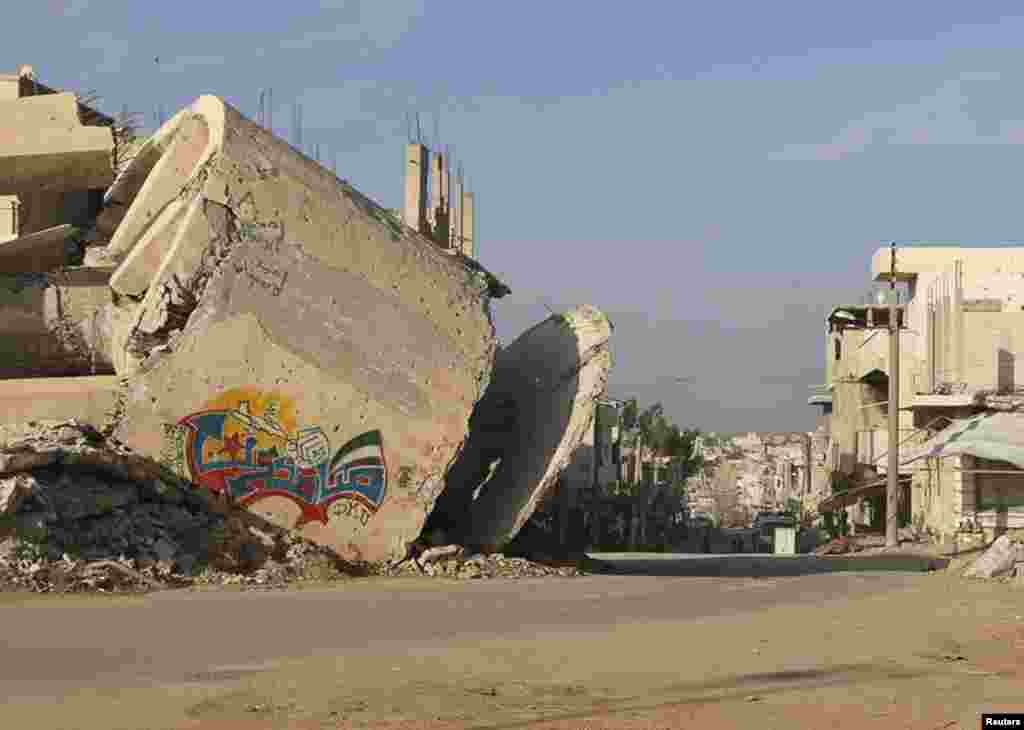 The word "Steadfast" is seen on a graffiti on a damaged building in al-Manshiyeh neighborhood in Deraa, Dec. 7, 2014.
