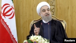 FILE - Iranian President Hassan Rouhani speaks in Tehran after returning from the annual United Nations General Assembly, Sept. 29, 2015. 