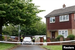 Police officers stand outside the home of Thomas Mair, named by local media as the man who was arrested after Labour MP Jo Cox was murdered in her constituency near Leeds, Britain, June 17, 2016.