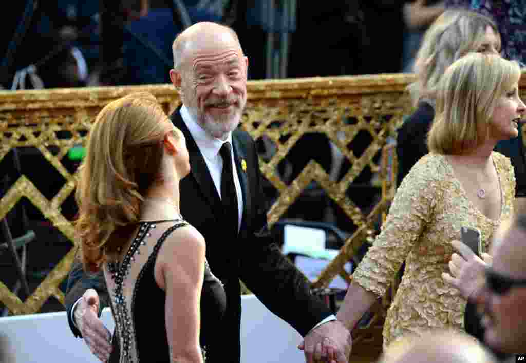 J. K. Simmons, left, and Michelle Schumacher arrive at the Oscars on Feb. 28, 2016, at the Dolby Theatre in Los Angeles. 