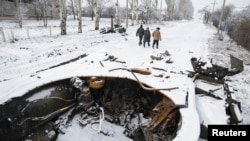 An Indian policeman fires a teargas shell towards demonstrators during a protest against the recent killings in Kashmir, in Srinagar.