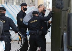 Belarusian police officers detain a man in Minsk, Belarus, July 15, 2020.
