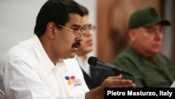 Venezuela's Vice President Nicolas Maduro (L) speaks during a meeting with political and military leader at Miraflores Palace in Caracas, March 5, 2013 in this photo provided by Miraflores Palace.