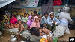 FILE - Rohingya Muslims, who crossed over from Myanmar into Bangladesh, rest inside a school compound at Kutupalong refugee camp, Bangladesh, Oct. 23, 2017. 