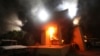 FILE - The U.S. Consulate in Benghazi is seen in flames during a protest by an armed group said to have been protesting a film being produced in the United States, Sept.11, 2012. 