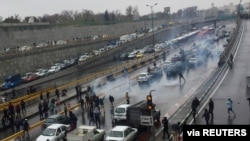 FILE - People protest against increased gas price, on a highway in Tehran, Iran, Nov. 16, 2019. 
