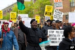 FILE - Demonstrators protest in the streets as they march for Freddie Gray to Baltimore's City Hall, in Baltimore, April 25, 2015.