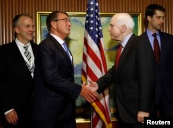 U.S. Defense Secretary Ash Carter, second left, meets with U.S. Senator John McCain on the sidelines of the IISS Shangri-La Dialogue in Singapore, June 3, 2016.