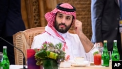 FILE - Crown Prince Mohammed bin Salman of Saudi Arabia takes his seat ahead of a working lunch at the G20 Summit, Nov. 15, 2022, in Nusa Dua, Bali, Indonesia. 