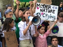 A speaker addresses young climate activists outside the United Nations in New York, Aug. 30, 2019. The rally came ahead of a Sept. 21 Youth Climate Summit at the U.N.; adult leaders will meet two days later for a climate summit of their own.