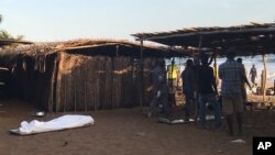 A body is seen laying on the beach were gunmen staged an attack in Grand Bassam, Ivory Coast, March 13, 2016. 