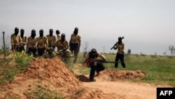 Rebel fighters members of the Liwa Brigade, of which Maher Rahhal was part, are seen training in the northeastern city of Deir Ezzor, on March 25, 2014.