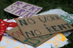 FILE - Signs lay on the ground after people gathered outside of an apartment complex to protest the eviction of one of the tenants in Mount Rainier, Maryland, August 10, 2020.