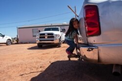 FILE - A little girl plays in her family compound in Tuba City, Ariz., April 22, 2020. People living in rural communities and on reservations are among the toughest groups to count in the 2020 census.