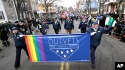 FILE - U.S. Rep. Seth Moulton, D-Mass., center without hat, marches with members of OutVets, a group of gay military veterans, during the St. Patrick's Day parade in Boston's South Boston neighborhood, March 15, 2015.