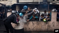 Palestinians line up for a meal in Rafah, Gaza Strip, Feb. 16, 2024. International aid agencies say Gaza is suffering from shortages of food, medicine and other basic supplies as a result of the war between Israel and Hamas.