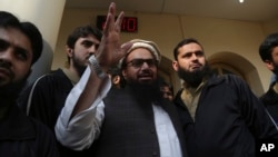 Hafiz Saeed, head of the Pakistan's Jamaat-ud-Dawa group waves to supporters at a mosque in Lahore, Pakistan, Nov. 24, 2017.