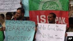 FILE - People protest against an Islamic State-claimed attack on a shrine earlier this year, in Peshawar, Pakistan, Feb. 17, 2017.