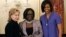 FILE - First lady Michelle Obama and Secretary of State Hillary Rodham Clinton present the 2010 International Women of Courage Award to Jestina Mukoko of Zimbabwe on March 10, 2010, at the State Department in Washington.