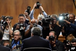 Attorney General William Barr is photographed as he sits down to testify before the Senate Judiciary Committee on Capitol Hill in Washington, May 1, 2019.