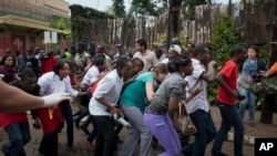 Civilians who had been hiding inside during the gun battle manage to flee from the Westgate Mall in Nairobi, Sept. 21, 2013.