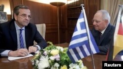 German Finance Minister Wolfgang Schaeuble (R) meets Greek Prime Minister Antonis Samaras in Athens, July 18, 2013. 