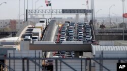 FILE - Vehicles line up to enter the U.S. from Mexico at El Paso, Texas, March 29, 2019. A 2½-year-old Guatemalan child has died after crossing the border, becoming the fourth minor known to have died after being detained by the Border Patrol since December.